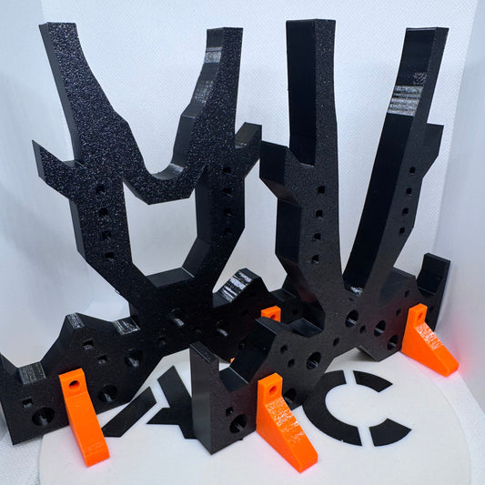 Black and orange tool with multiple prongs on a white background
